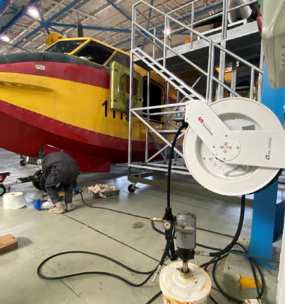 CL-215 firefighting seaplane alongside lubrication equipment and maintenance platforms