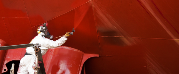 Industrial operator using a protective coating equipment